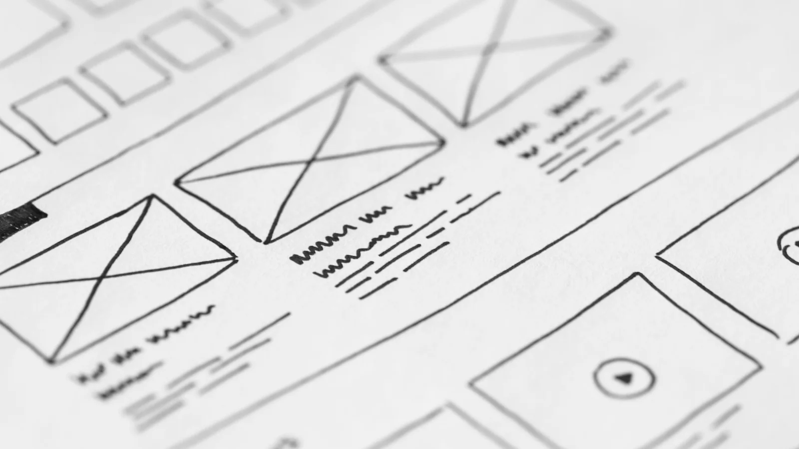 Hand-drawn website wireframe sketches on white paper