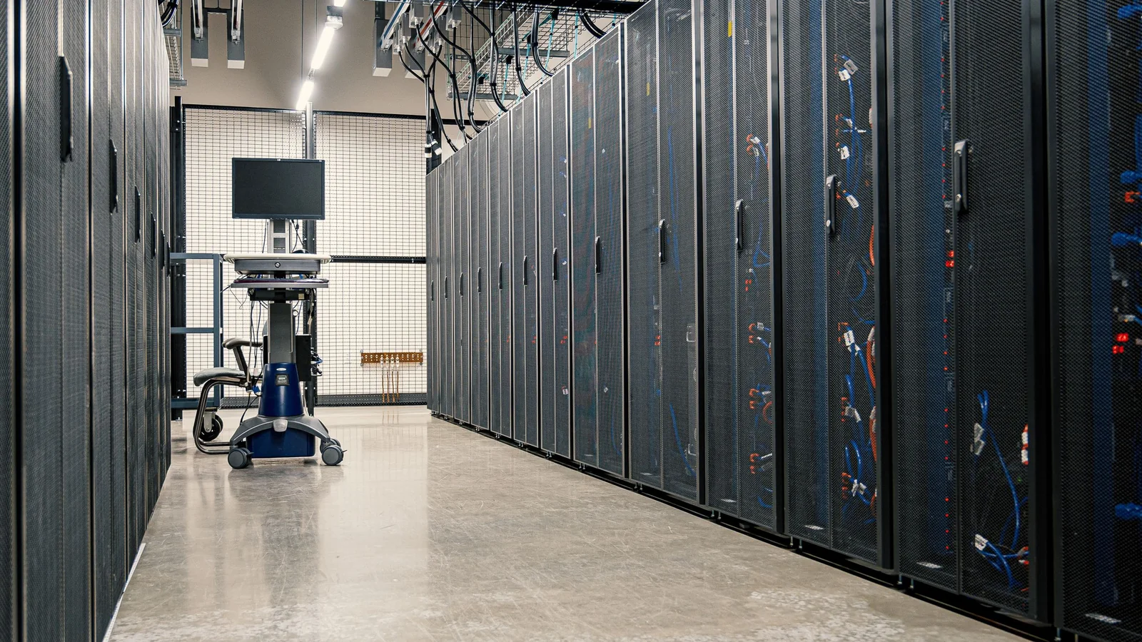 A long aisle of server cabinets in a modern data center