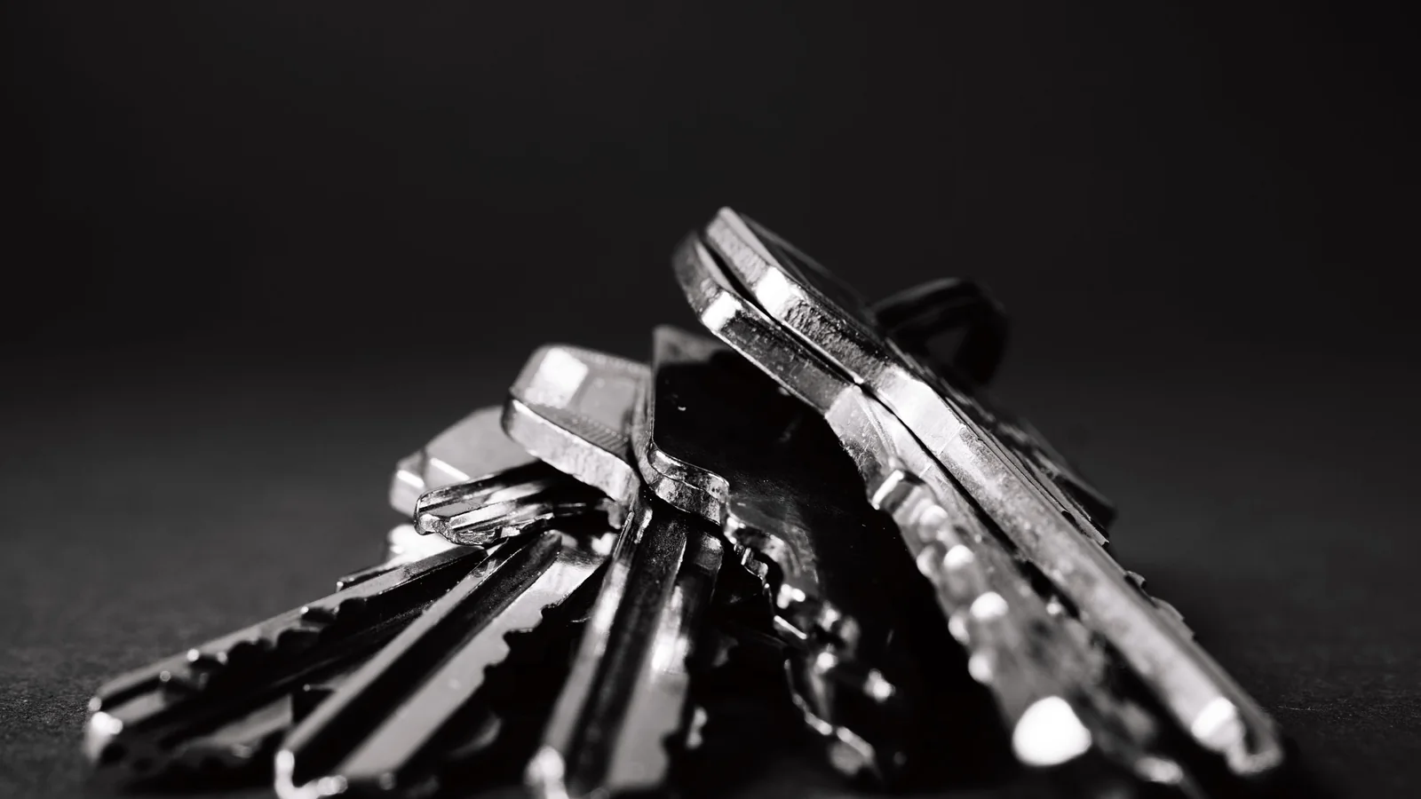 Black-and-white close-up of a bunch of metal keys on a ring