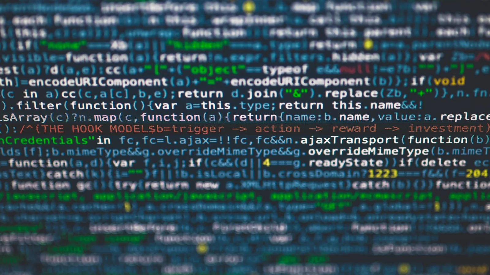 Colorful code on a terminal screen above a backlit keyboard